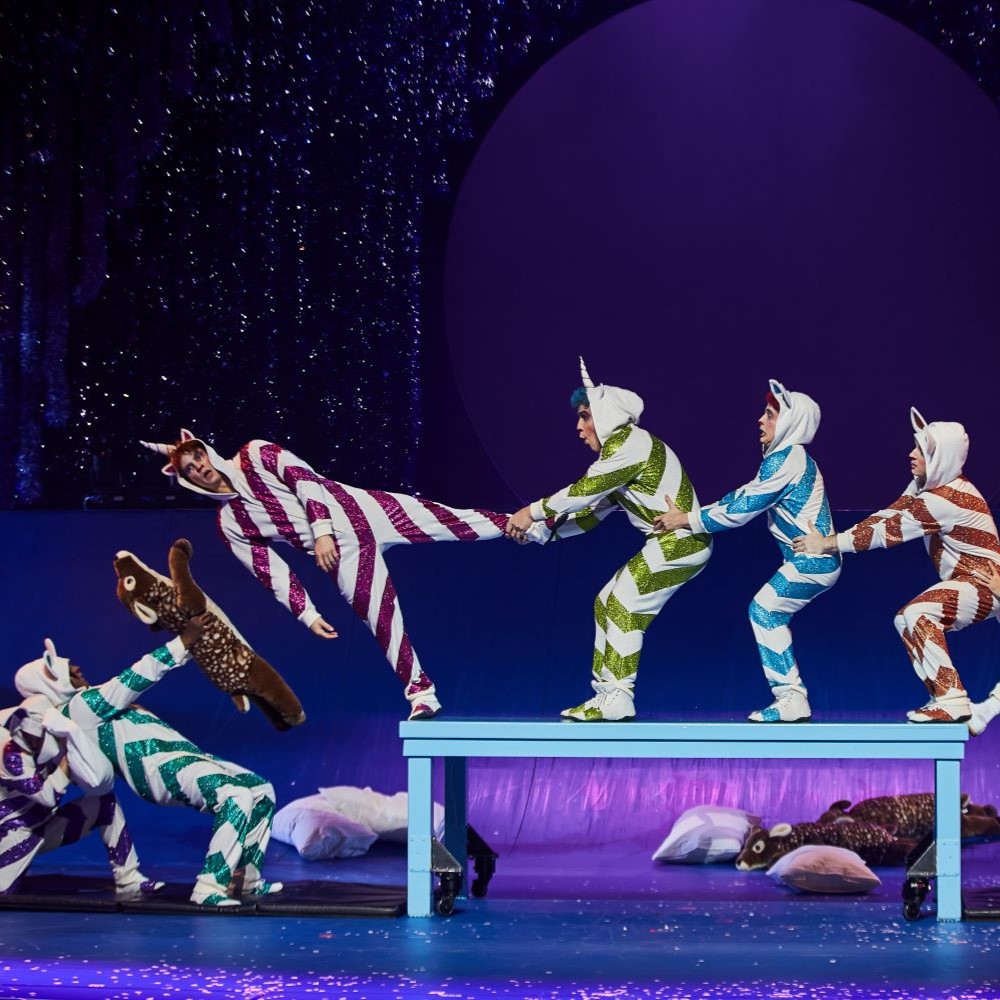 Performers dressed as unicorns in pajamas